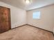 This empty bedroom includes a window and a wood door, and is fully carpeted at 1119 Indigo Rd, Ormond Beach, FL 32174