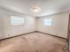 This empty bedroom includes two windows and is fully carpeted at 1119 Indigo Rd, Ormond Beach, FL 32174