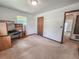 Carpeted bedroom featuring a built-in shelving unit and a view of another room through the doorway at 1119 Indigo Rd, Ormond Beach, FL 32174