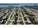 An aerial view of a residential neighborhood with access to a body of water surrounded by trees and other shrubbery at 10 Juniper Dr, Ormond Beach, FL 32176