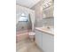 Vintage bathroom featuring a pink bathtub, tiled walls, and classic fixtures at 10 Juniper Dr, Ormond Beach, FL 32176