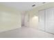 Neutral-toned bedroom featuring sliding closet doors and ample natural light at 10 Juniper Dr, Ormond Beach, FL 32176