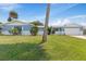 A charming one story residential home with a two car garage and a manicured lawn with shrubs at 10 Juniper Dr, Ormond Beach, FL 32176