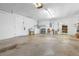 Spacious garage with laundry area, utility sink, storage, and access to additional workspace and the rest of the home at 10 Juniper Dr, Ormond Beach, FL 32176
