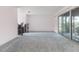 Spacious living room with sliding glass doors and plush carpeting at 10 Juniper Dr, Ormond Beach, FL 32176