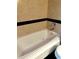 Close-up view of the bathroom soaking tub and black tile detail at 64 Ocean Palm S Dr # 64, Flagler Beach, FL 32136