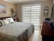 Comfortable bedroom with a large window, a queen-sized bed, and neutral decor at 64 Ocean Palm S Dr # 64, Flagler Beach, FL 32136