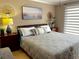 Inviting bedroom featuring a cozy bed, soft lighting, and decorative wall art at 64 Ocean Palm S Dr # 64, Flagler Beach, FL 32136