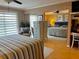 Bright bedroom featuring a striped bedspread, closet with mirrored doors, and a cozy sitting area at 64 Ocean Palm S Dr # 64, Flagler Beach, FL 32136