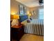 Bedroom with a striped bedspread, blue headboard, bedside tables, and decoratively framed art at 64 Ocean Palm S Dr # 64, Flagler Beach, FL 32136