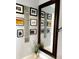 Hallway decorated with Gathering photos and a large mirror, creating a warm and inviting space at 64 Ocean Palm S Dr # 64, Flagler Beach, FL 32136