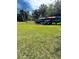 A rack of colorful kayaks sits on the lush, green lawn at 64 Ocean Palm S Dr # 64, Flagler Beach, FL 32136