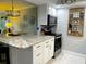 Well-equipped kitchen with a large island, white cabinets, and stainless steel appliances at 64 Ocean Palm S Dr # 64, Flagler Beach, FL 32136