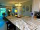 Open kitchen featuring granite countertops, pendant lighting, and a view of the living area at 64 Ocean Palm S Dr # 64, Flagler Beach, FL 32136