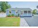 Charming blue house with landscaped yard and walkway at 2110 N Oleander Ave, Daytona Beach, FL 32118