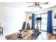 Bright exercise room with wood floors, ceiling fan, workout equipment, and sliding doors at 50 Ocean Palm Villa S, Flagler Beach, FL 32136