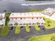 Aerial view of a condominium featuring lush landscaping, private parking, and proximity to the water at 50 Ocean Palm Villa S, Flagler Beach, FL 32136