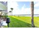 Beautiful exterior featuring a view of the water and a lush lawn with palm trees at 50 Ocean Palm Villa S, Flagler Beach, FL 32136