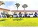 Lovely exterior view of the community with grassy yard and mature palm trees at 50 Ocean Palm Villa S, Flagler Beach, FL 32136