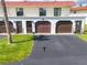 Charming condo building features well-maintained garages, colorful entry decor, and a lush lawn at 50 Ocean Palm Villa S, Flagler Beach, FL 32136