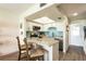 Bright kitchen with skylight, breakfast bar, white cabinetry and stainless steel appliances at 50 Ocean Palm Villa S, Flagler Beach, FL 32136