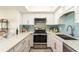 Modern kitchen features stainless steel appliances, white cabinets, and stylish backsplash at 50 Ocean Palm Villa S, Flagler Beach, FL 32136