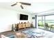 Bright living room with lake views, featuring a ceiling fan and a decorative cabinet at 50 Ocean Palm Villa S, Flagler Beach, FL 32136