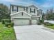 Two-story house with two-car garage, stone accents, and landscaped lawn at 535 Morgan Wood Dr, Deland, FL 32724