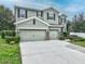 Two-story house with two-car garage, stone accents, and landscaping at 535 Morgan Wood Dr, Deland, FL 32724