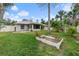 Backyard with grassy area, raised garden bed and palm trees at 928 George Hecker Dr, South Daytona, FL 32119