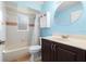 Clean bathroom with dark vanity, shower/tub combo, and white toilet at 928 George Hecker Dr, South Daytona, FL 32119