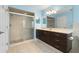Bathroom features dark vanity, shower, and tiled floors at 928 George Hecker Dr, South Daytona, FL 32119