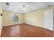 Bright bedroom with hardwood floors and ceiling fan at 928 George Hecker Dr, South Daytona, FL 32119