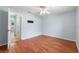 Light blue bedroom with wood flooring and ceiling fan at 928 George Hecker Dr, South Daytona, FL 32119