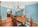 Bright dining room features hardwood floors and view into kitchen at 928 George Hecker Dr, South Daytona, FL 32119
