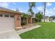 Brick facade with a stone-accented walkway and lush landscaping at 928 George Hecker Dr, South Daytona, FL 32119