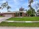 Beautiful brick home features manicured lawn, mature landscaping and a welcoming entrance at 928 George Hecker Dr, South Daytona, FL 32119