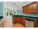 Bright kitchen with wood cabinets, stainless steel appliances, and a breakfast nook at 928 George Hecker Dr, South Daytona, FL 32119