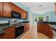 Kitchen with wood cabinets, stainless steel appliances, and granite countertops at 928 George Hecker Dr, South Daytona, FL 32119