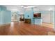 Open living room with hardwood floors and a view of the kitchen at 928 George Hecker Dr, South Daytona, FL 32119