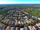 Wide aerial view of a residential neighborhood, surrounded by nature, trees and lakes at 211 Drummond Ln, Deland, FL 32724