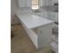 White kitchen island with ample counter space and electrical outlets at 6110 Everglades Dr, Port Orange, FL 32127