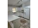 Galley style kitchen with white cabinets and patterned floor at 6110 Everglades Dr, Port Orange, FL 32127