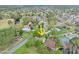 An aerial view displays the property surrounded by lush landscaping, golf course and mature trees at 100 Longspur Ct, Daytona Beach, FL 32119