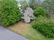 Aerial view of home and neighborhood with mature trees and landscaping at 100 Longspur Ct, Daytona Beach, FL 32119