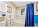 Clean bathroom with a bathtub/shower, white tiling, and a blue shower curtain at 100 Longspur Ct, Daytona Beach, FL 32119