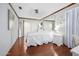 Bright bedroom features hardwood floors, white bedding, and decorative accents for a comfortable and inviting space at 100 Longspur Ct, Daytona Beach, FL 32119