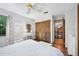 Serene bedroom features ceiling fan, decor, and wood closet doors, creating a peaceful retreat at 100 Longspur Ct, Daytona Beach, FL 32119