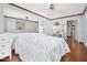 Spacious bedroom featuring hardwood floors, a large mirror, and access to the rest of the house at 100 Longspur Ct, Daytona Beach, FL 32119