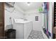 Functional laundry room with modern washer and dryer, storage shelves, and stylish flooring at 100 Longspur Ct, Daytona Beach, FL 32119